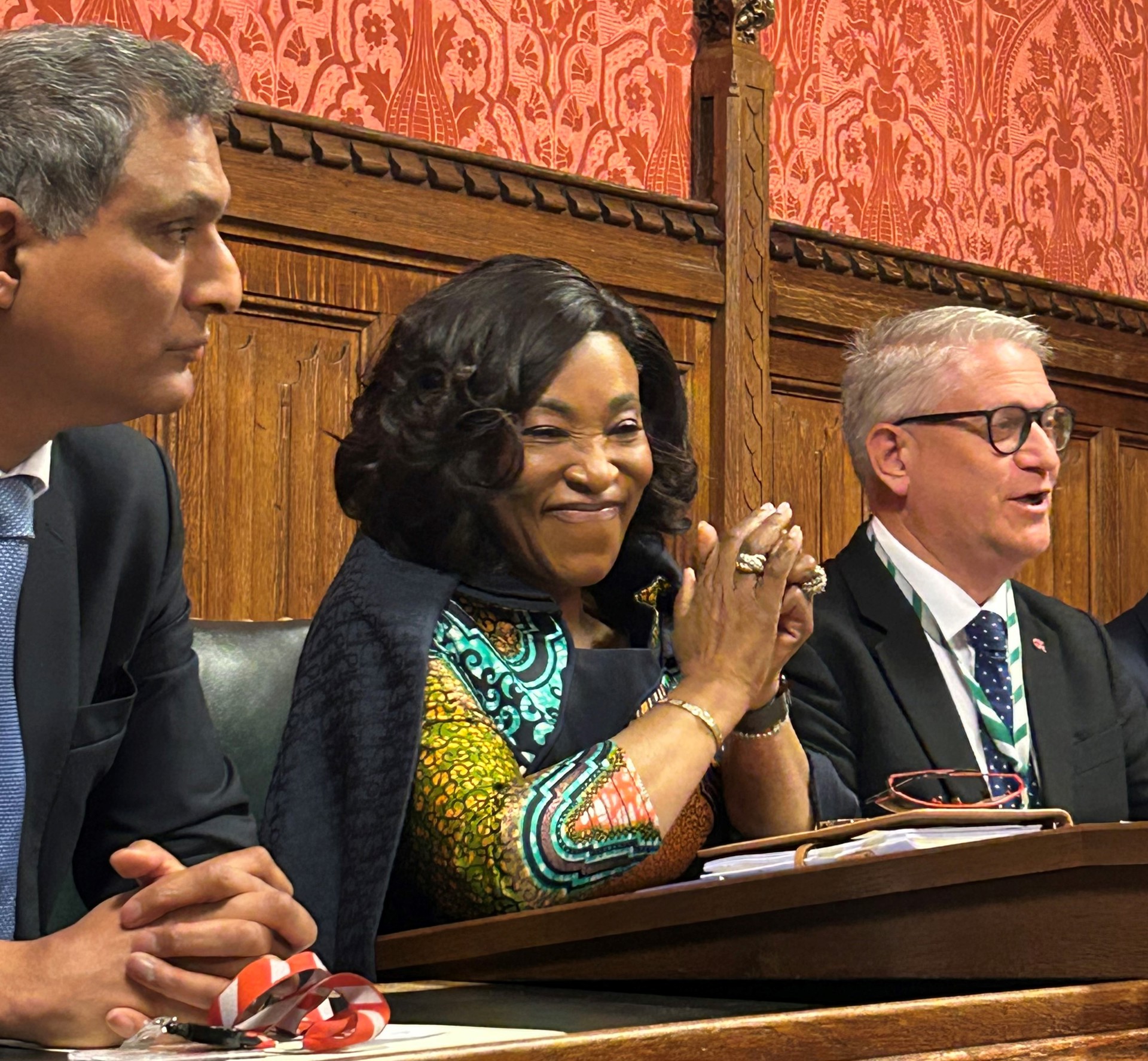 Commonwealth Secretary-General, Shirley Botchwey, with Lord Kamall and Andrew Rosindell M.P. sitting at a desk addressing parliamentarians.