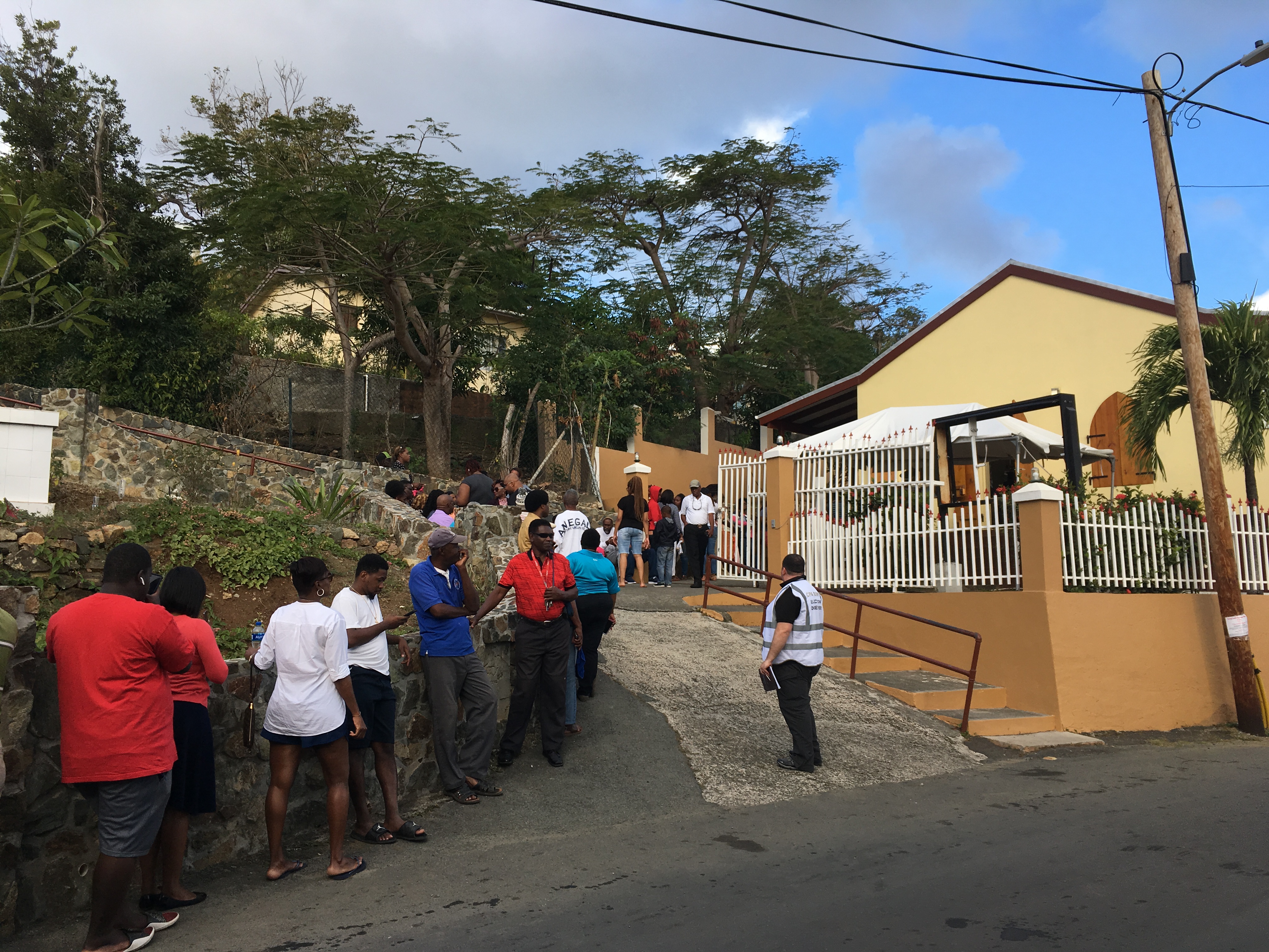 Voters queue at a polling station on election day