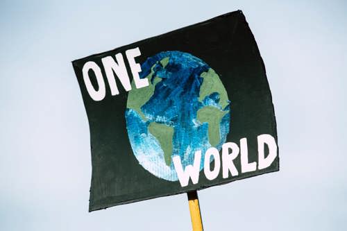 A photo of a poster with the words 'once world' over a drawing of planet earth