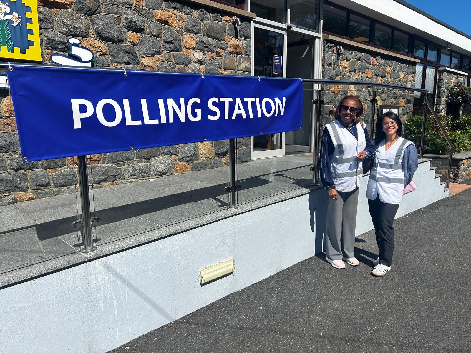 Hon. Alvina Reynolds (Head of Mission) and Maggie El Beleidi (Election Administrator) prepare to observe voting