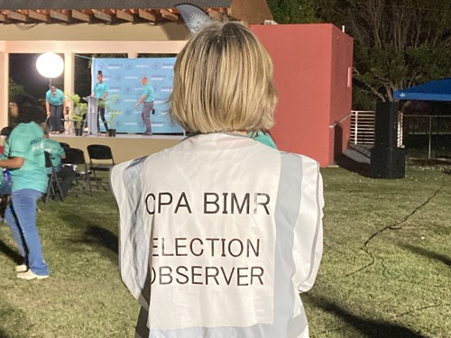 Picture of an Election Observer wearing their high-visibility jacket during the Caymans Islands Election observation mission in 2025.